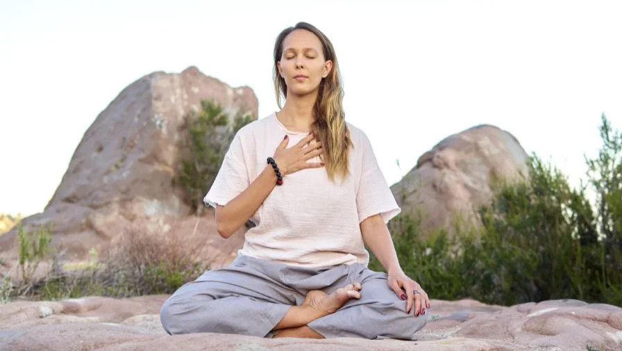 A woman meditates as a form of urge surfing