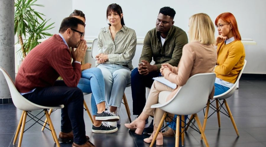 Men and women sitting in circle, displaying the Intensive Outpatient Program