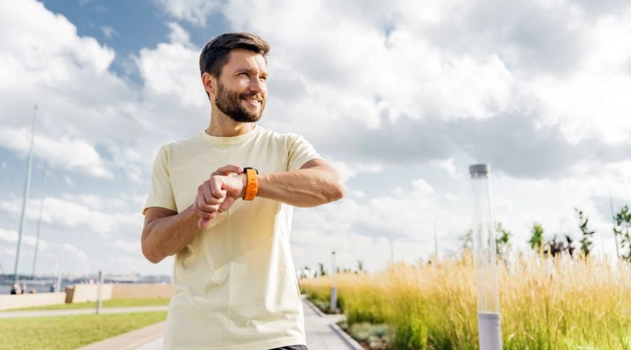 Image of a man with hand on watch about to start running - Heart Health Improvements and Slowing Heart Disease