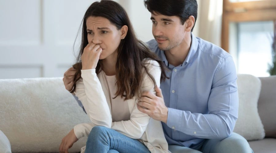 Image of a husband providing support and expressing empathy to his wife who is in despair