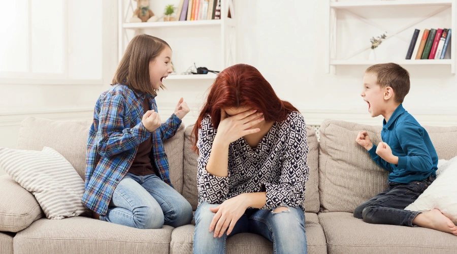 Exhausted stay-at-home mom feeling overwhelmed while managing household chores and childcare
