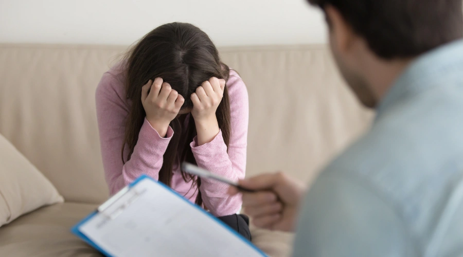 Image of adult reflecting on childhood trauma and seeking mental health support