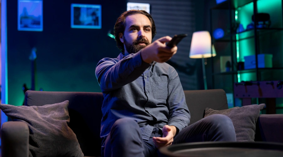 Image of a Man watching TV, representing how media influences perceptions of mental health